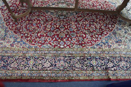 An Isfahan red and ivory ground carpet, 12ft 10in by 9ft 10in.